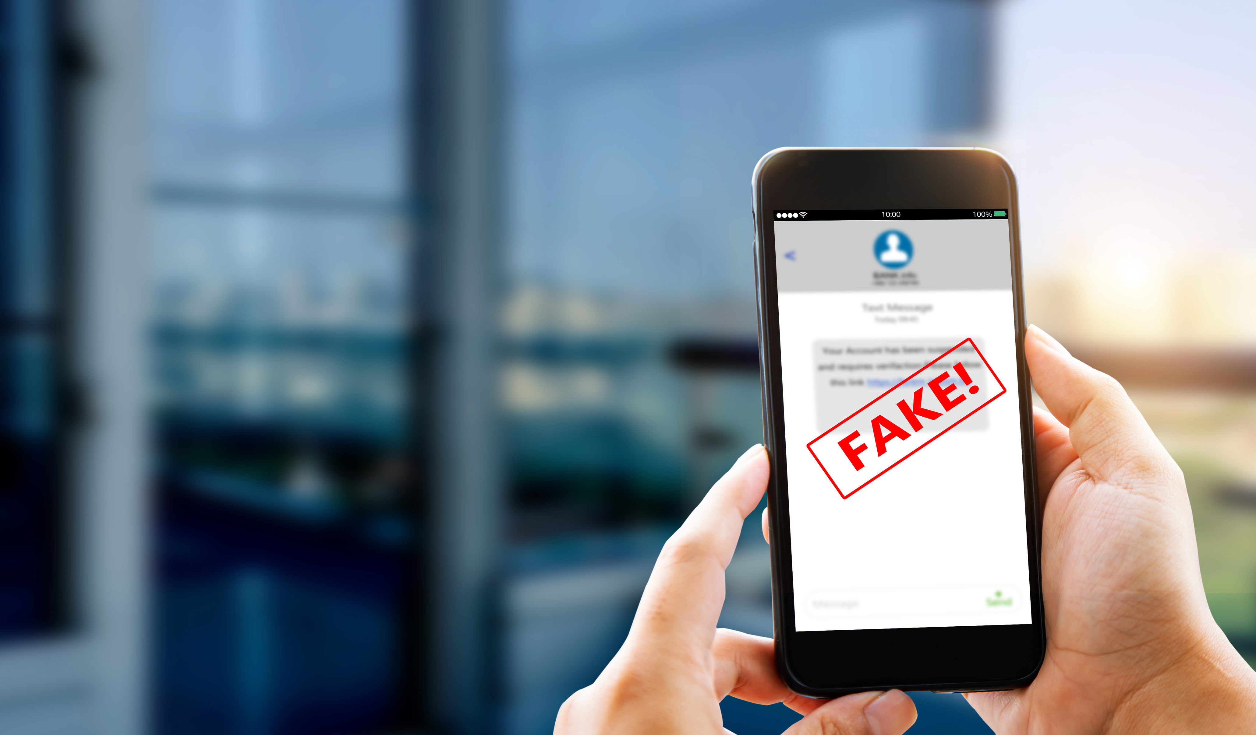 Image of phone with word FAKE